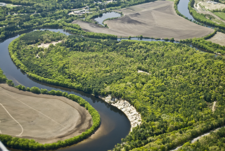 aerial view of winding river through a forested and agricultural landscape